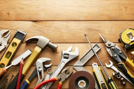 Well-organized workshop with hardware tools laid out on a workbench